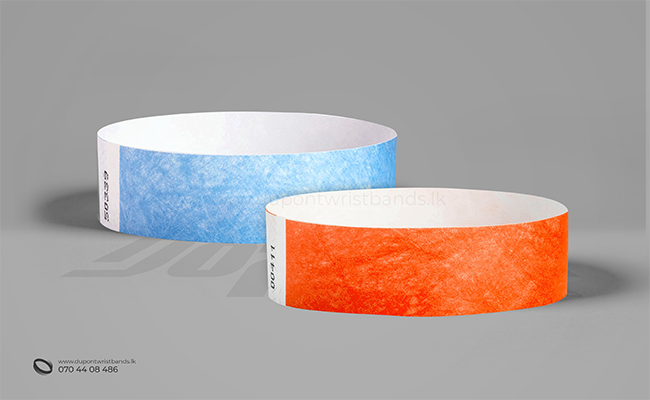 light blue and orange solid colour paper hand bands / wristbands